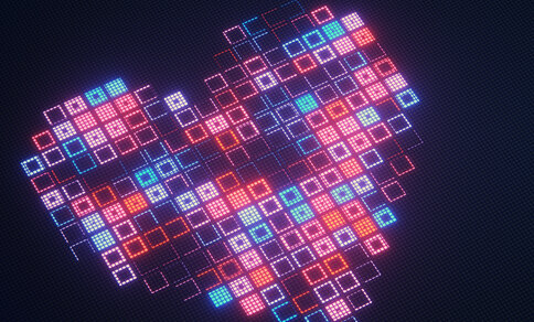 Digital illustration of a heart shape composed of numerous glowing square pixels in shades of red, pink, orange, turquoise and blue against a dark background.